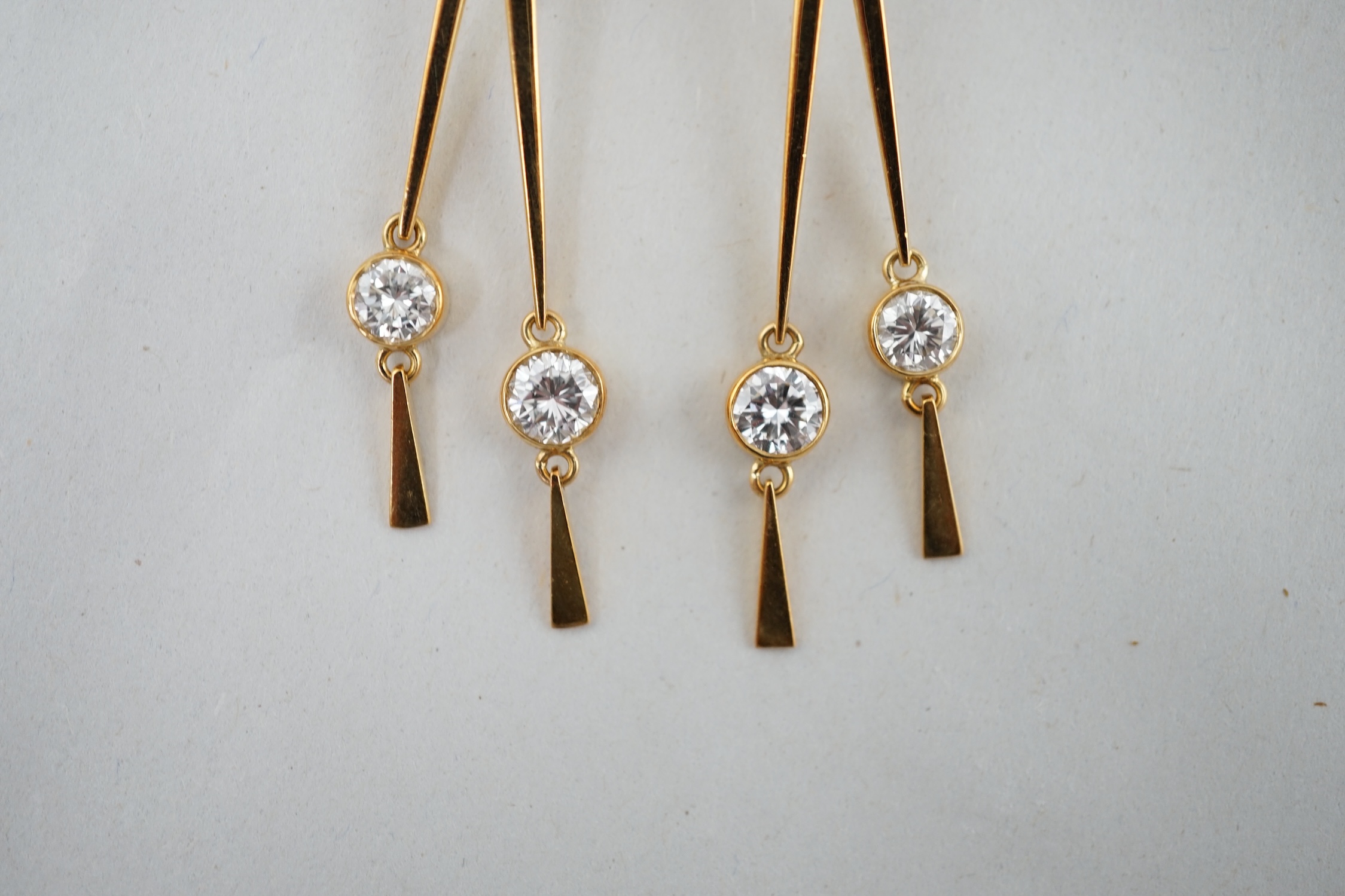 A pair of modern 18ct gold and three stone diamond set double drop ear clips